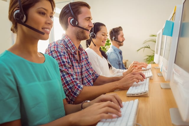 Business team working together at a call centre wearing headsets.jpeg