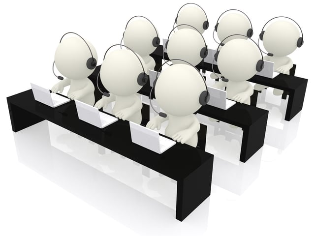 Call center operators sitting at their desks - isolated over a white background.jpeg