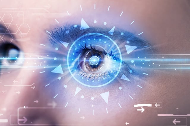 Modern cyber girl with technolgy eye looking into blue iris.jpeg