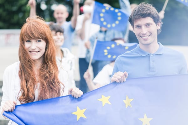 Picture of young community workers with european union flags